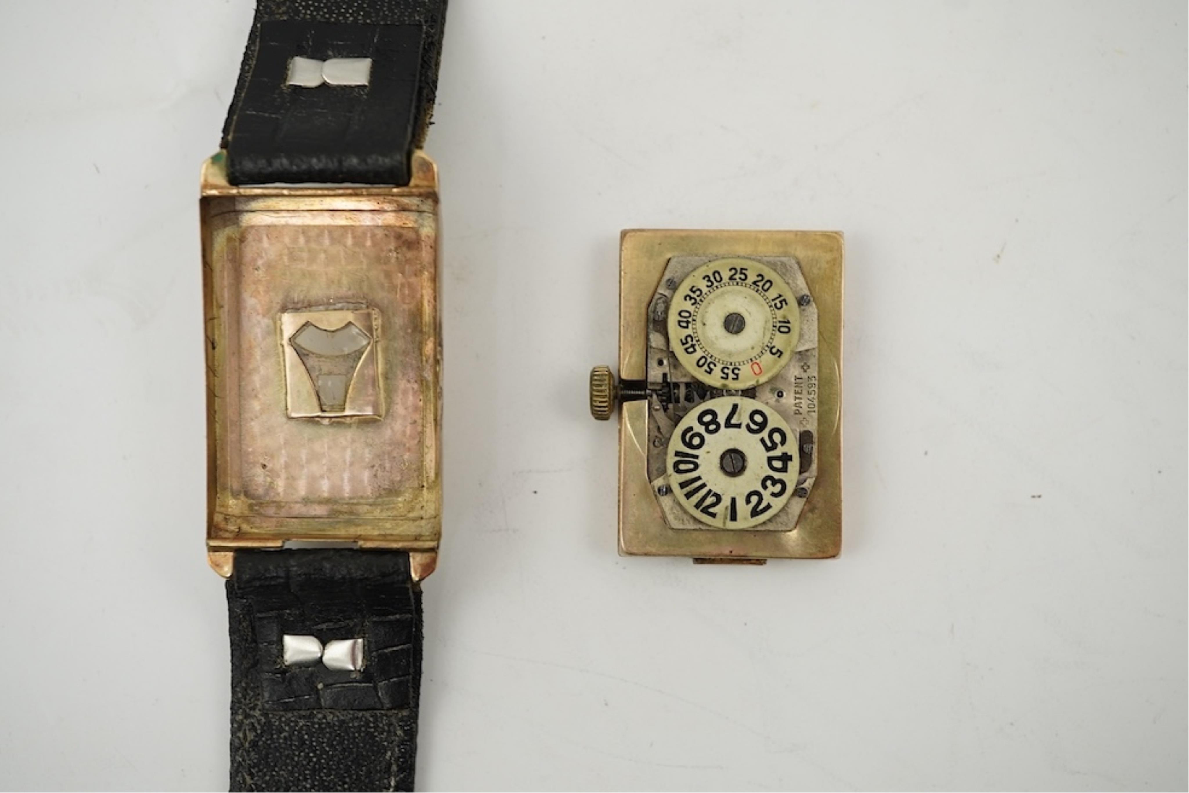 An early 1930's 9ct gold Swiss 'Jump Hour' rectangular cased manual wind wrist watch, case diameter 20mm, on a leather strap, gross weight 23 grams.